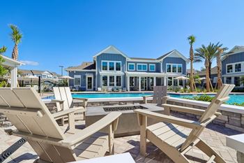 Pool deck with adirondack chairs and fire feature